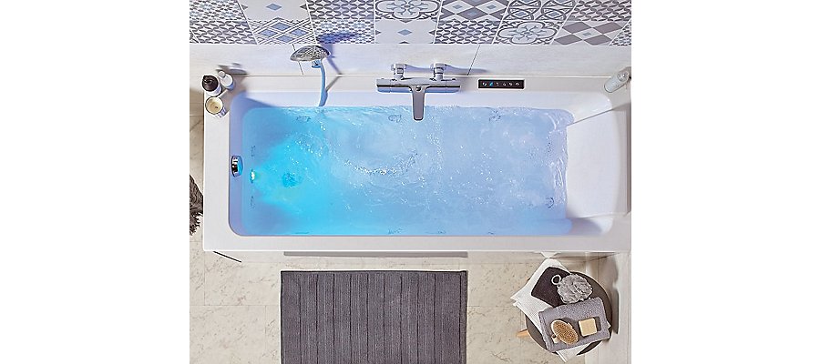 Du carrelage mural à motifs bleus et blancs pour embellir une salle de bains contenant une baignoire BALNÉO