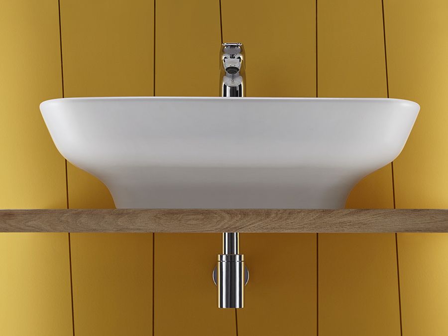 Une vasque dans une salle de bains de couleur jaune